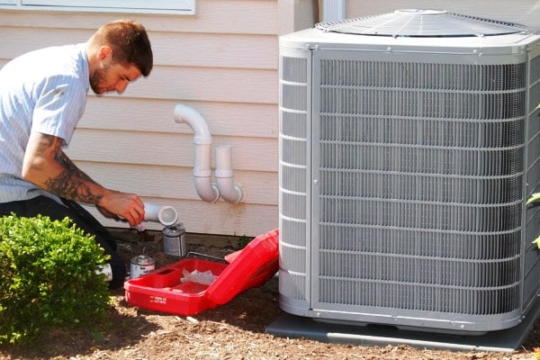 Technician installating central air conditioner in Mississauga, ON