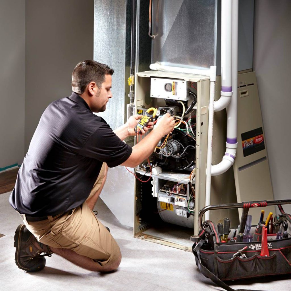 Technician tuning up furnace in Mississauga, Ontario